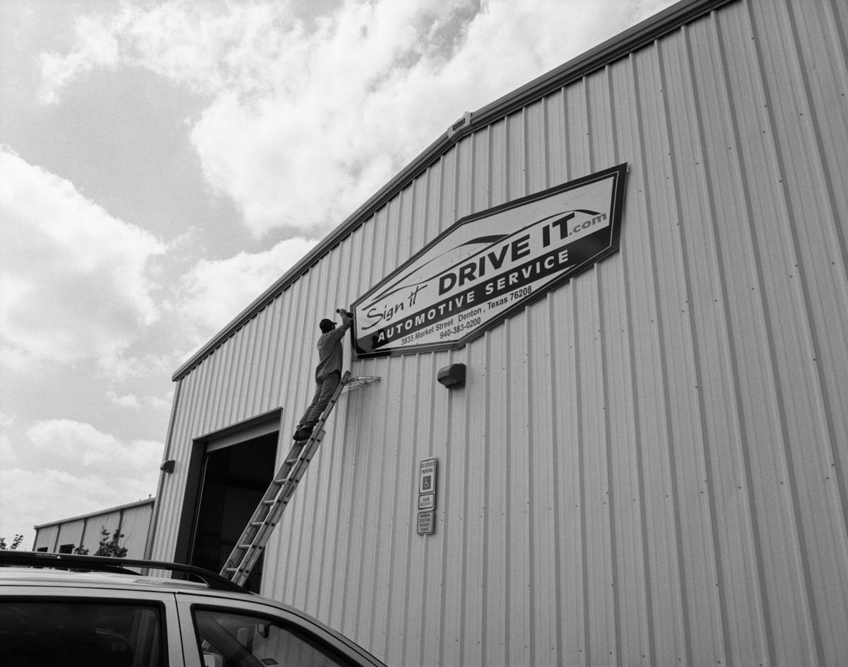 Sign It Drive It Service — putting up our sign on Market Street
